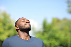 Man with closed eyes facing the sun