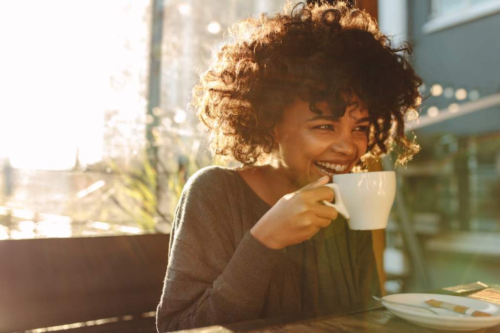 Woman drinking coffee in the sun