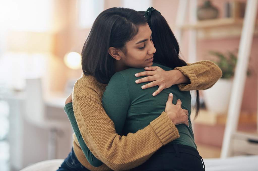 Two women hugging