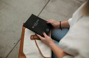 woman-holding-black-mission-journal