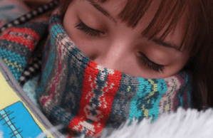 Closeup of woman's face wrapped in colorful scarf