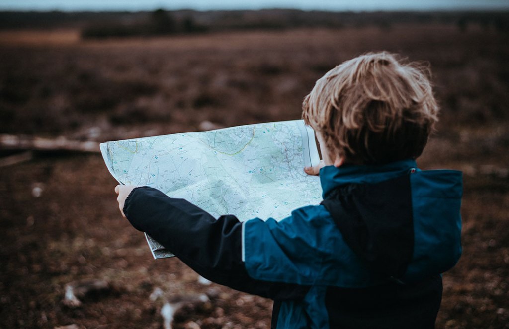 child holding map