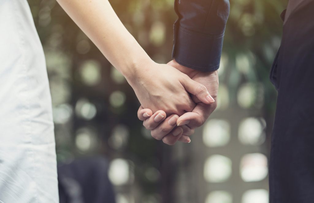 Bride and groom holding hands