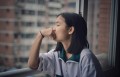 Girl looking out window