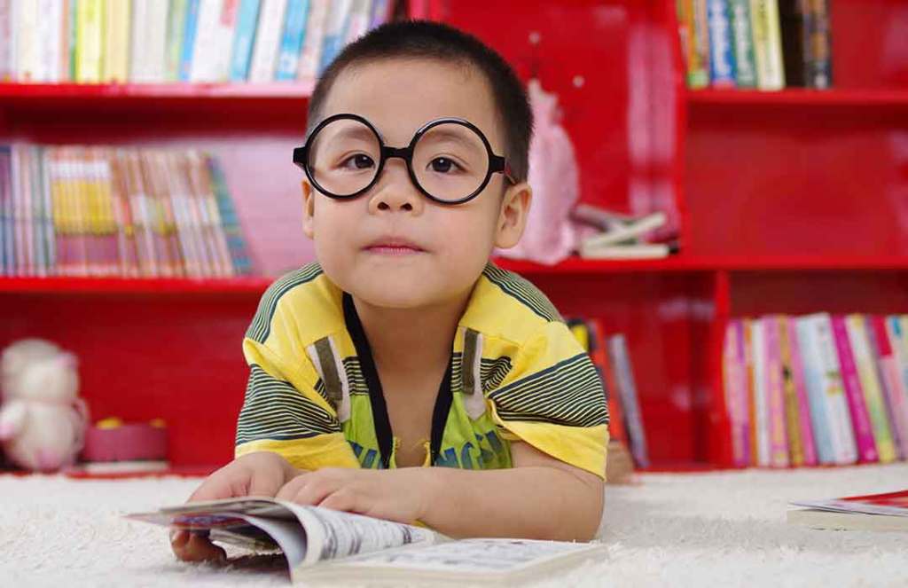 Child in the library with glasses