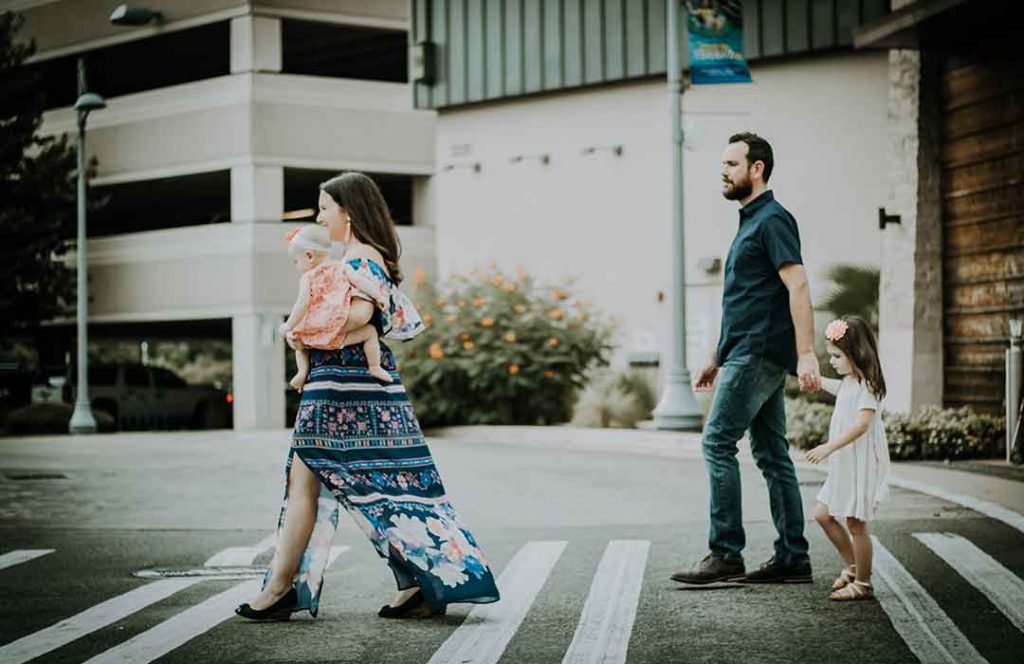 family walking across crosswalk