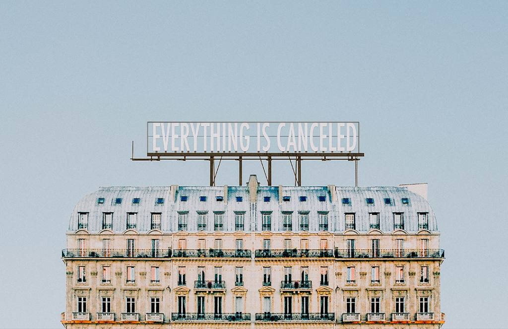 building with "everything is canceled" billboard