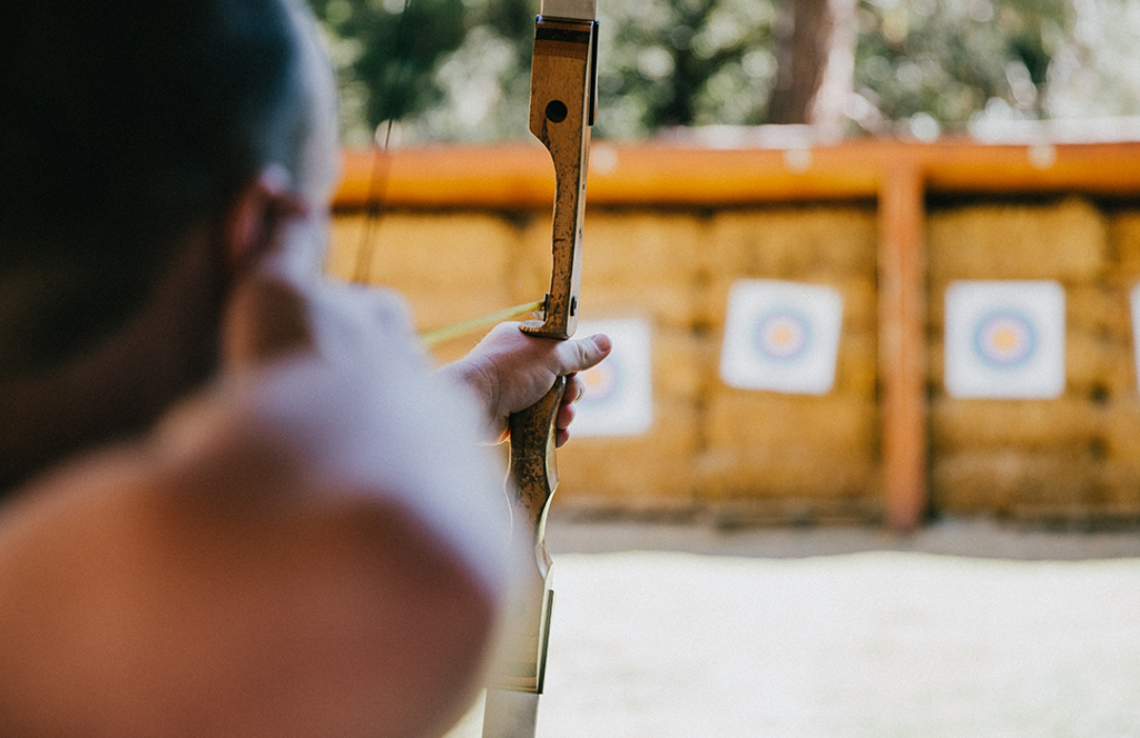 person holding bow and arrow