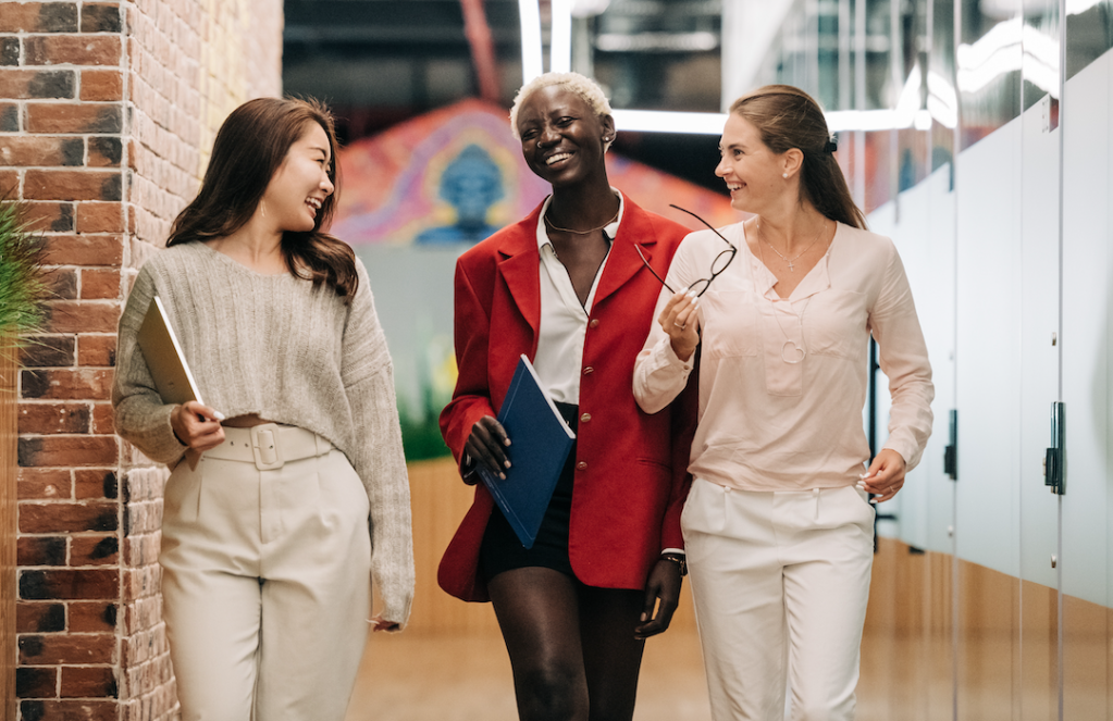 diverse-successful-businesswomen-smiling-and-walking-together-in-modern-workplace