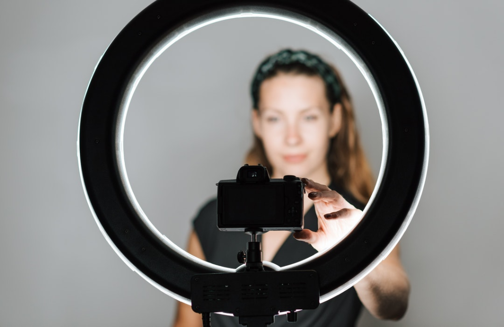 Woman taking selfie with ring light