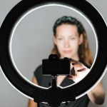 Woman taking selfie with ring light