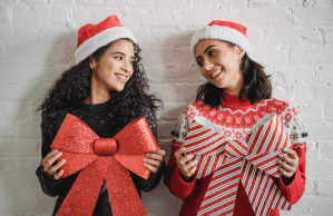 Girlfriends with Santa hats and Christmas holiday bows