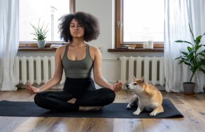 woman-doing-yoga-beside-dog