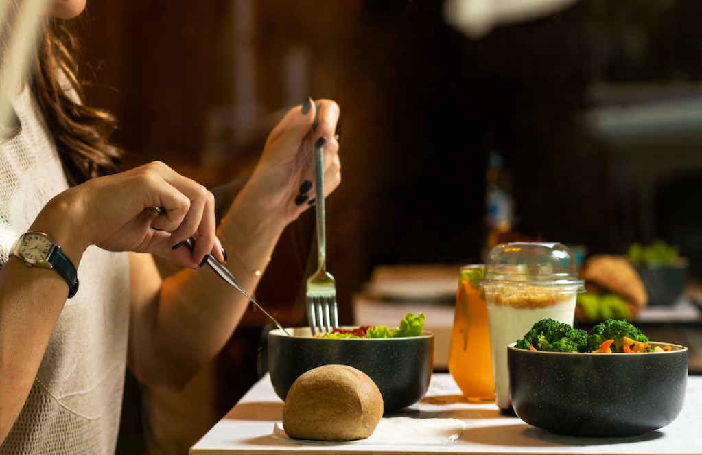 woman-eating-tasty-chicken-salad-with-dessert