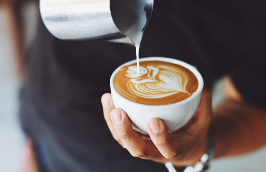 person-performing-coffee-art