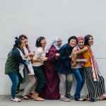 woman-falling-in-line-holding-each-other