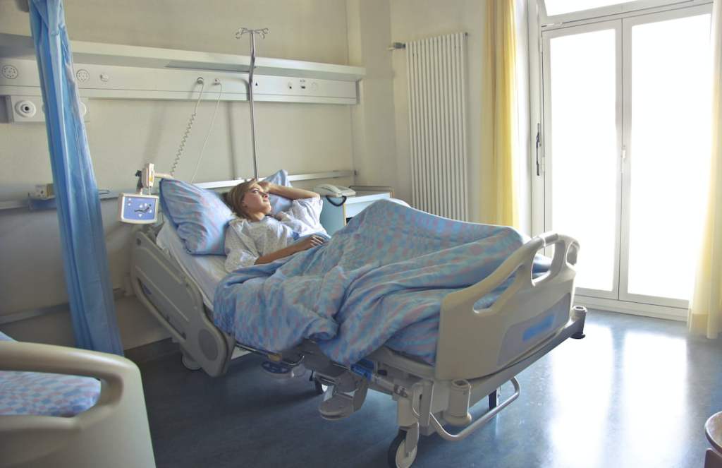 photo-of-woman-lying-in-hospital-bed