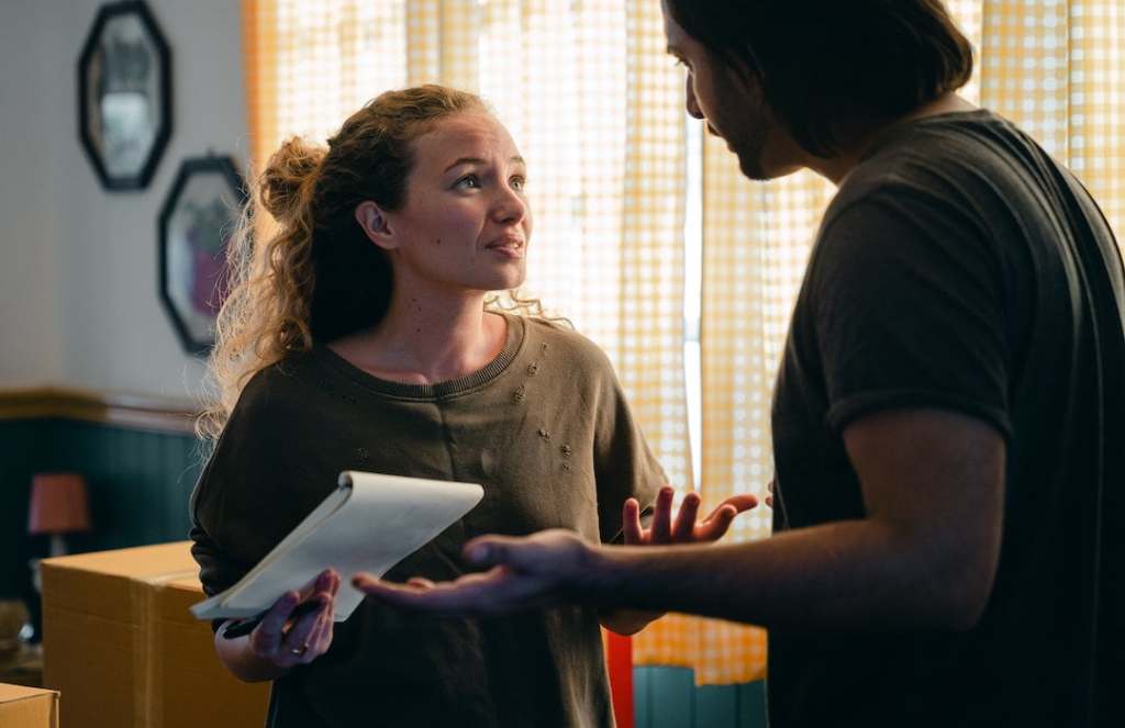 worried-couple-with-notebook-looking-at-each-other