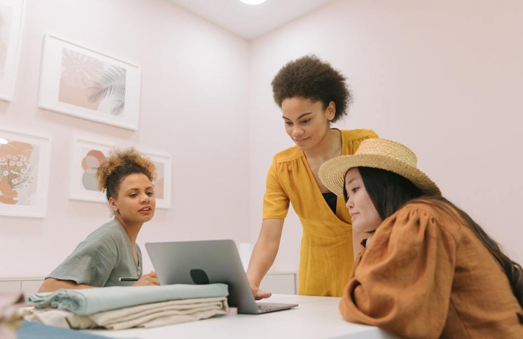Three young women staring at laptop