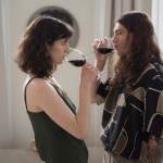 Couple drinking glasses of wine while looking at each other