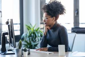 Young professional woman at her desk working in an office