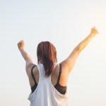Woman with her fists in the sky