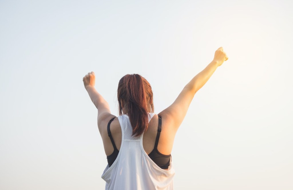 Woman Holding Her Arms Up As If Things Are Fall From The Sky Stock