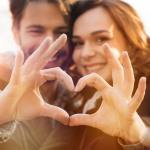Couple making a heart with hands