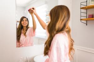 Woman drawing a heart on mirror and smiling