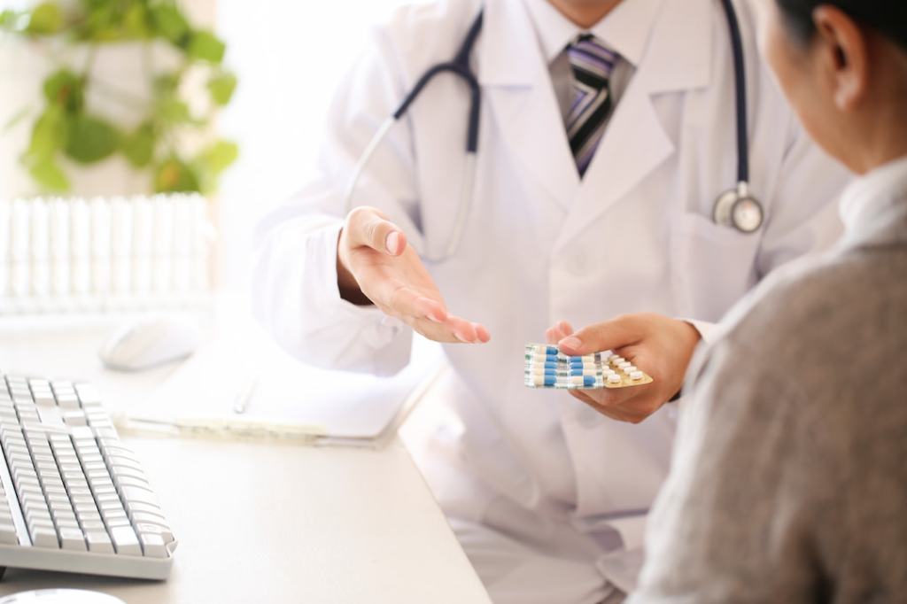 Doctor handing medication to a patient