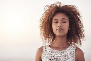 Woman standing with her eyes closed