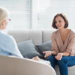 Woman on a couch talking to a therapist