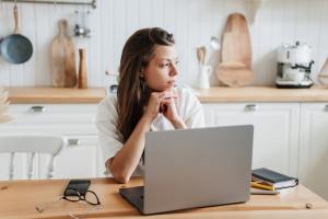 Woman sitting with a laptop at a table