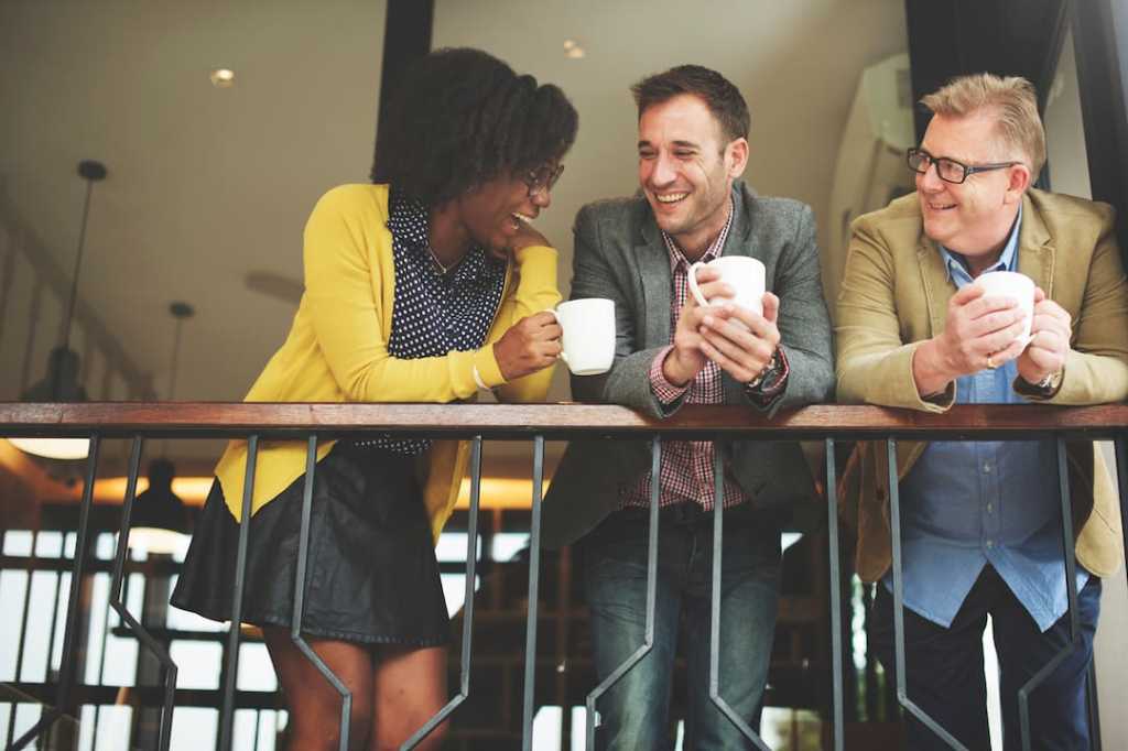 Three people chatting with coffee