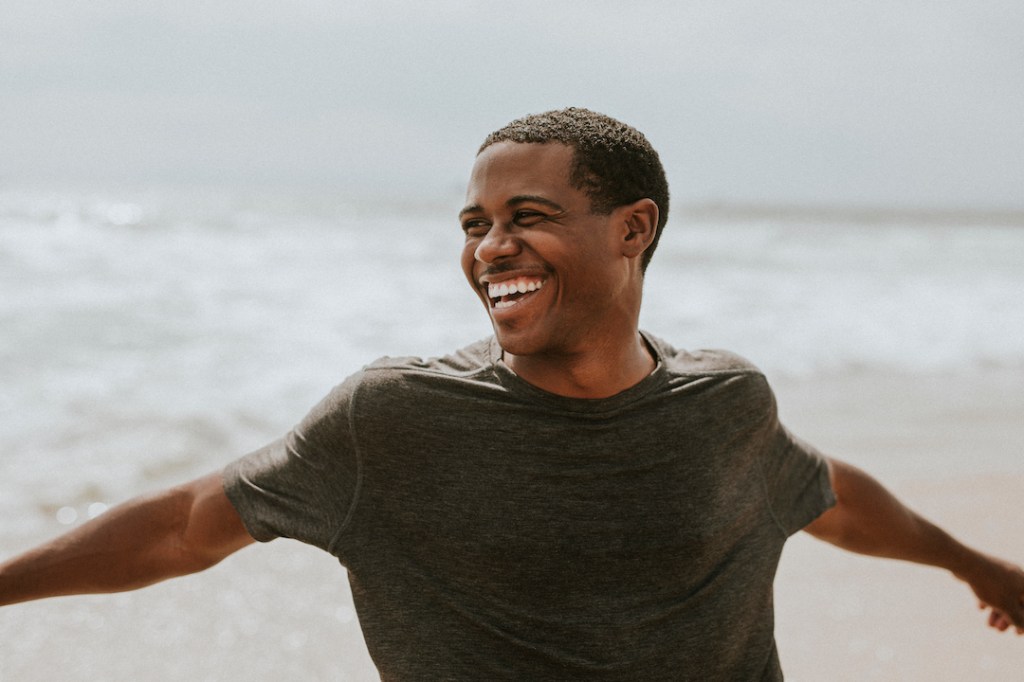 Cheerful man enjoying life on the beach