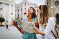 Two women reading a map and laughing