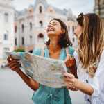 Two women reading a map and laughing