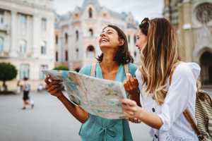 Two women reading a map and laughing