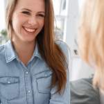 Woman in a denim shirt smiling at her therapist as they discuss ADHD