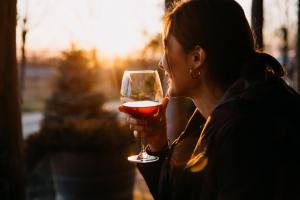 Woman drinking wine at sunset