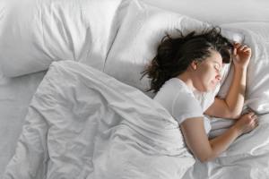 Woman sleeping in her bed