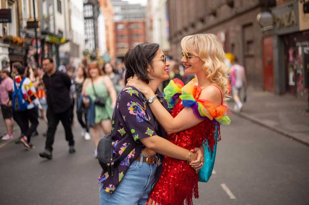 Two people holding each other at Pride parade