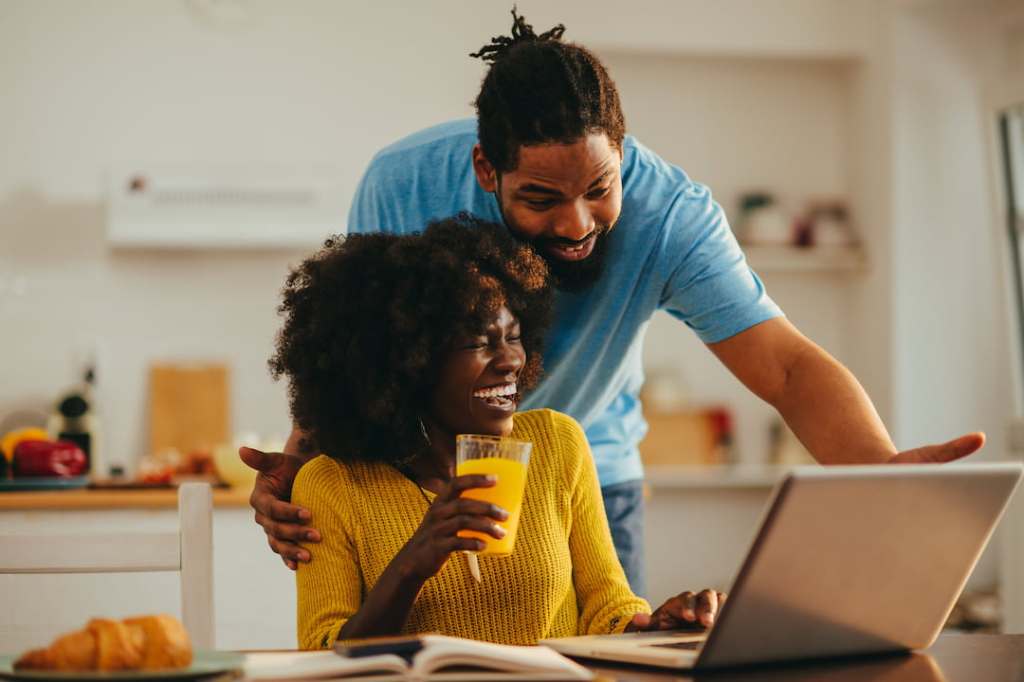 Woman and man looking at a laptop