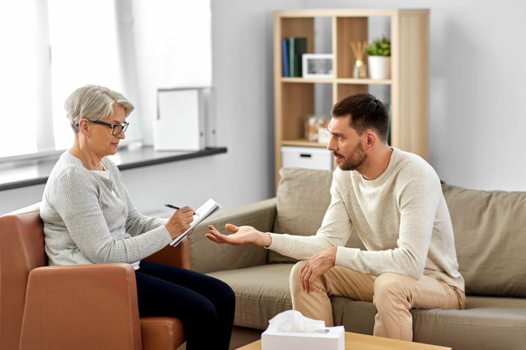 Man speaking with therapist from a couch