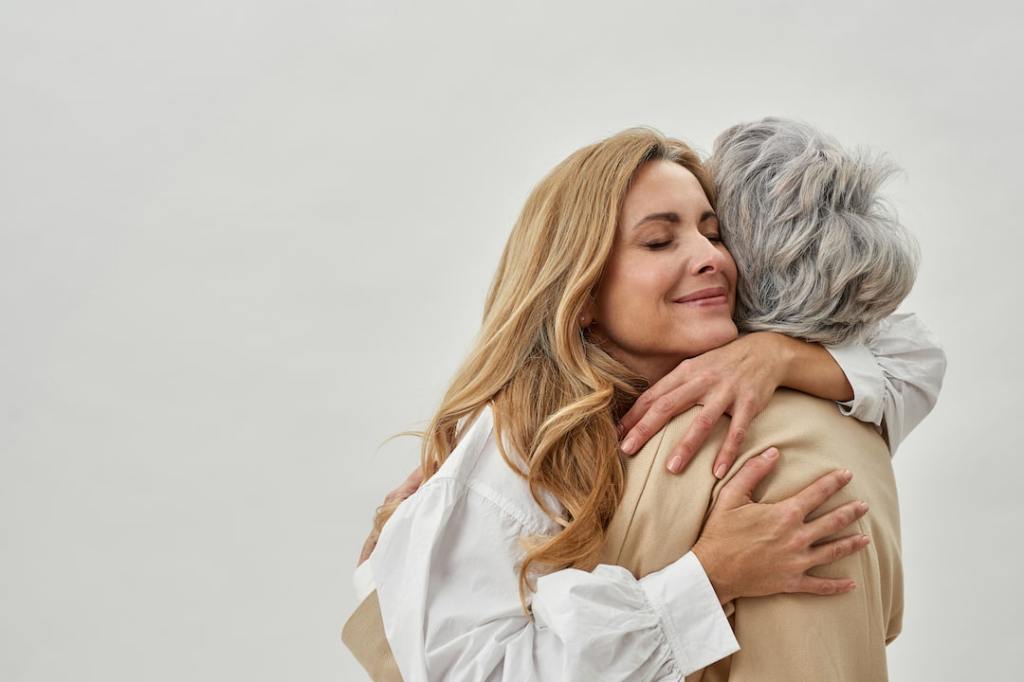 Mother and daughter hugging each other