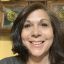 Woman smiling in front of stained glass