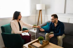 Medical professional prescribing medicine to male client