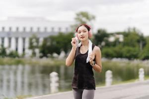 Woman in headphones walking after a workout