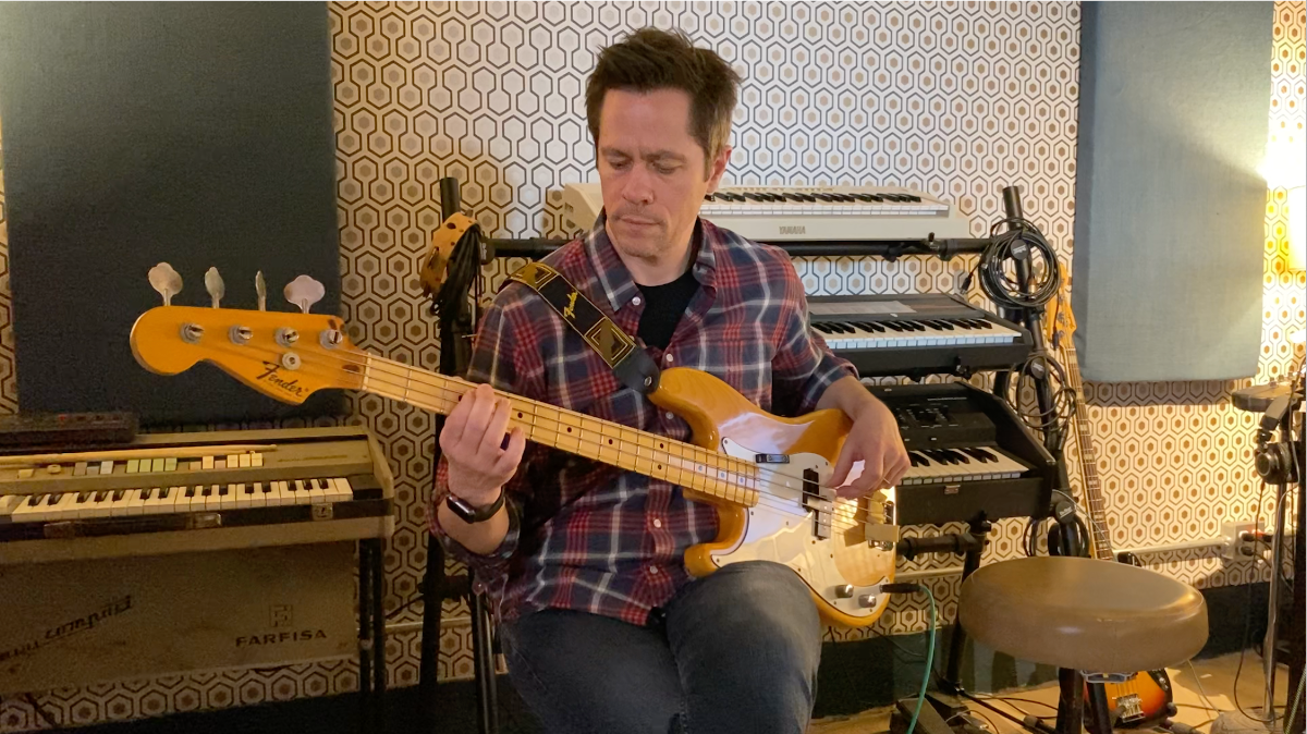 James Lavino playing bass in the recording studio