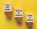 Wooden blocks reading, "I was just joking," "Don't be so dramatic," and "You're so sensitive" on a yellow background